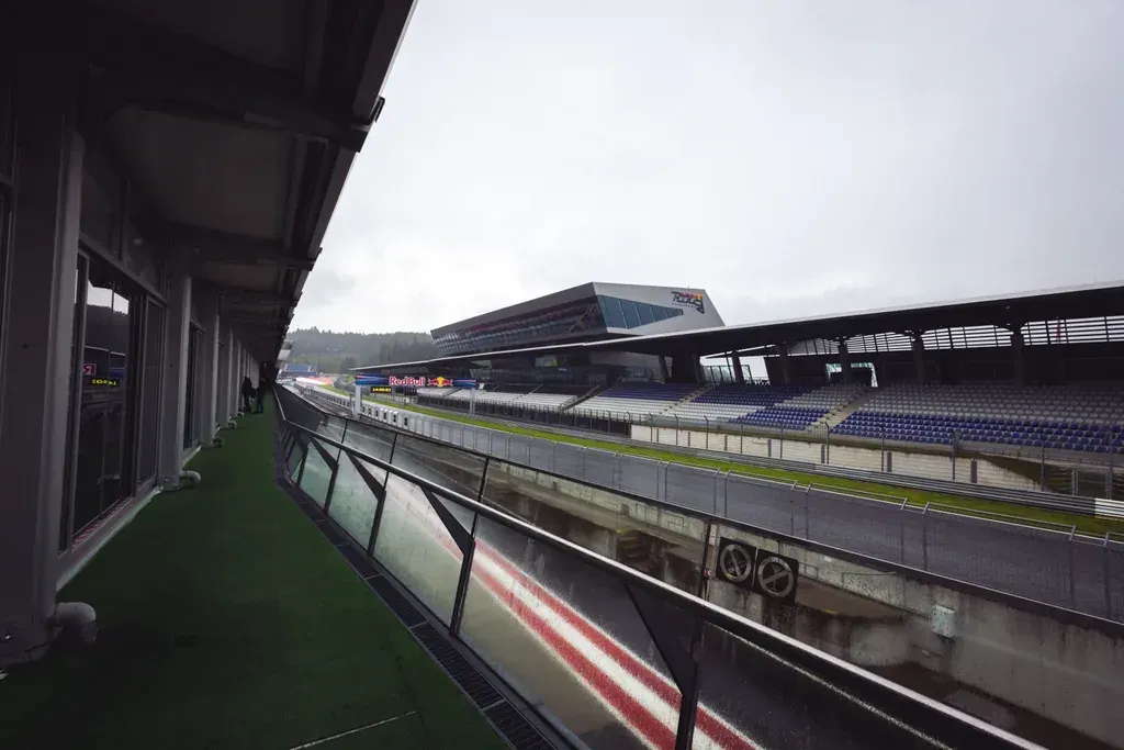Boxengasse und Fahrerlager-Gebäude des Red Bull Rings in Spielberg bei bewölktem Himmel